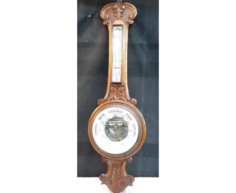 Victorian all barometer/thermometer in an oak carved casing, 85cm tall 