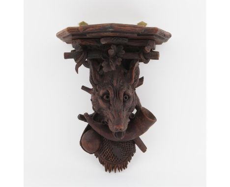 Late 19th/early 20th century, shelf bracket carved with a wolf's head hunting horn branches and foliage, 22 cms wide 29 cms h