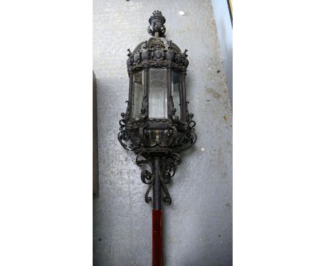 Venetian style wrought iron lantern, of octagonal form with bevelled glass and scrollwork design, on a velvet covered metal s