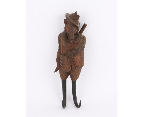 Late19th/early 20th century novelty coat hook in the form of a fox, dressed in hunting apparel, holding a rifle, with two  ho