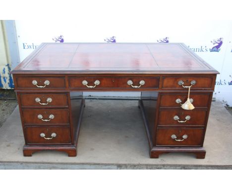 Mahogany partner's desk, the leather inset top over three frieze drawers on either side above pedestals each with three gradu