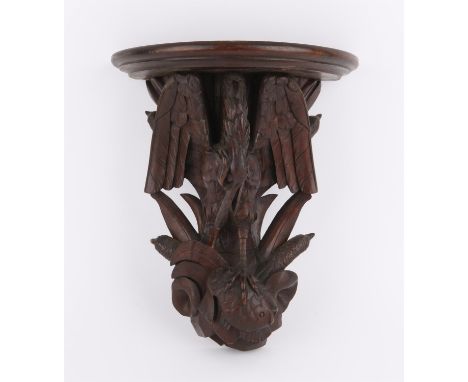 Late 19th/early 20th century Black Forest carved wood wall bracket with a heron holding a fish and reeds and rushes, 25 x 36c