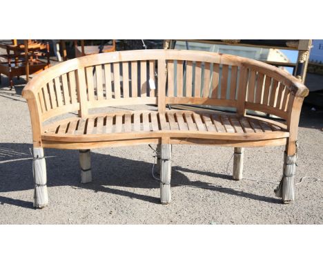 Teak curved garden bench 164 cm wide, 87 cm highCondition Report:  Still with cardboard wrapping around the legs, some cardbo