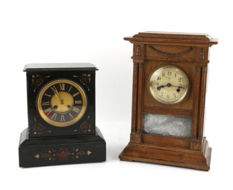 Victorian slate mantel clock, with black chapter ring, the twin train French movement striking on a gong, 29 cm high and an o