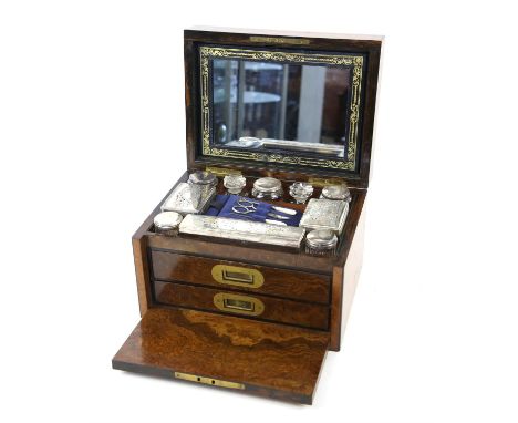 Mid 19th century burr walnut dressing box, of rectangular form, the hinged lid with brass inset shield enclosing a spring loa