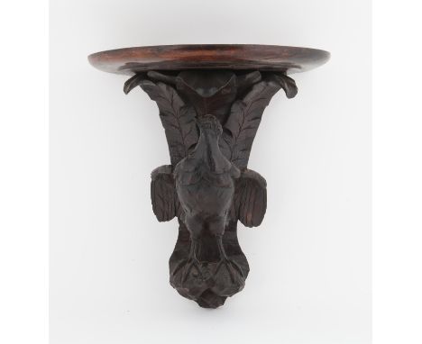 Late 19th/early 20th century wall bracket carved with a bird with outstretched wings, 33 cms high 27 cms widePROVENANCE; A co