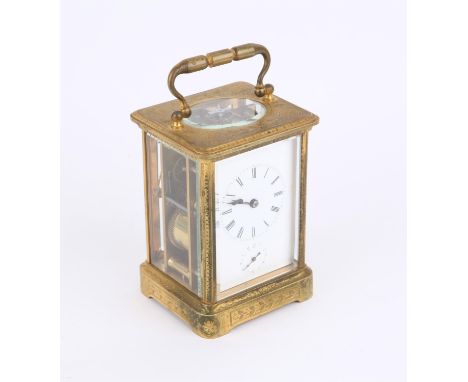 Brass and four glass carriage clock with lever movement, engraved decoration, the white enamelled dial with Roman numerals an