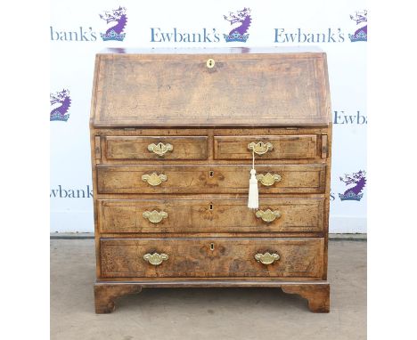George II walnut bureau, with boxwood and ebony stringing, the sloping fall enclosing pigeonholes and drawers over two short 