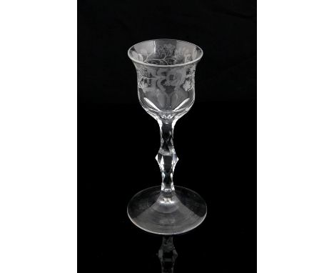 18th century wine glass with bell shaped bowl engraved with Jacobite rose and other flowers, on facetted knopped stem and dom