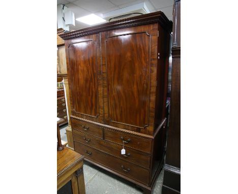 19th century mahogany linen press with panelled doors enclosing slides over two short and two long drawers on bracket feet, h