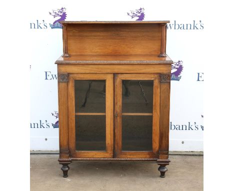 19th century rosewood chiffonier, with beaded edges, the raised back with shelf on turned supports over a pair of glazed door