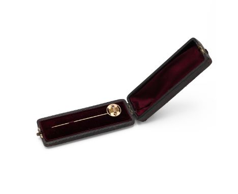 A ruby and seed pearl stickpin, unmarked, tests between 12ct and 13ct gold, Total weight 31.1g, cased. 