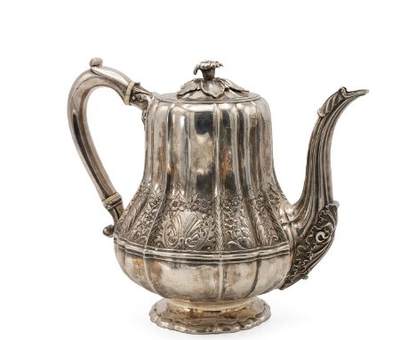 George III, &nbsp;a silver teapot of boubous outline decorated with shell, leaf and flower border, standing on a raised shape