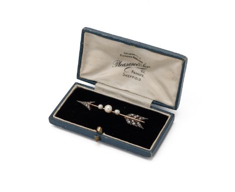 An Edwardian diamond and pearl arrow brooch, the arrow head and flights set with rose cuts, with a trio of graduated pearls (