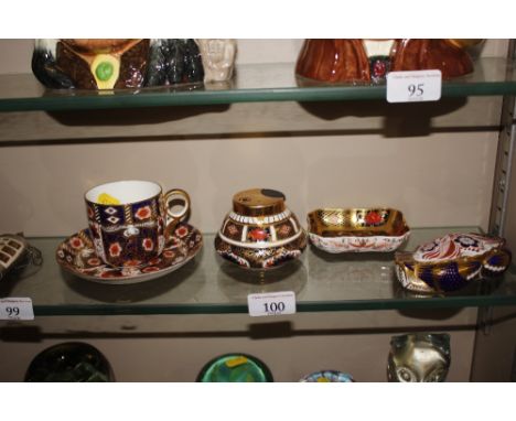 A Crown Derby tea cup and saucer, Crown Derby lighter, Crown Derby "Crab" paperweight and a pin dish