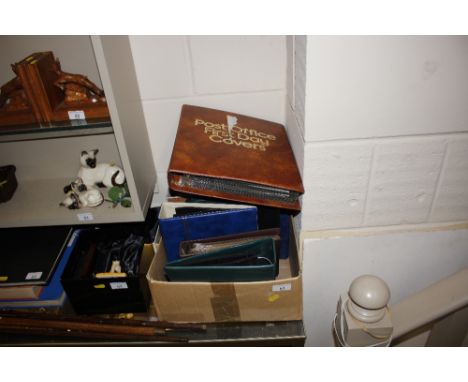 A postcard album and contents containing mostly cats; various empty postcard albums and an album of First Day covers