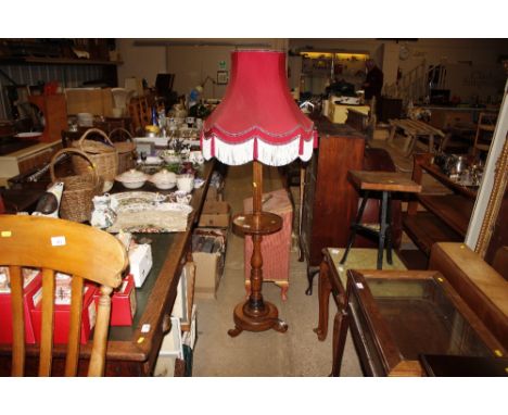 An oak standard lamp with tasseled shade 