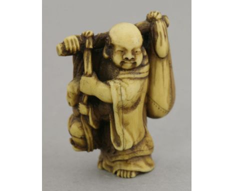 An attractive ivory Netsuke,mid-19th century, of a smiling Hotei, a yoke on one shoulder suspending his treasure sack and the