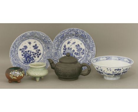 A pair of blue and white bowls, probably Kangxi, densely painted with birds, rocks and flowers, mark of yu (jade), 21cm, a bo