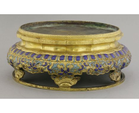 An unusual enamel and gilt metal Stand,18th/19th century, the lobed body with stylised flowers and scrolling below lotus gadr