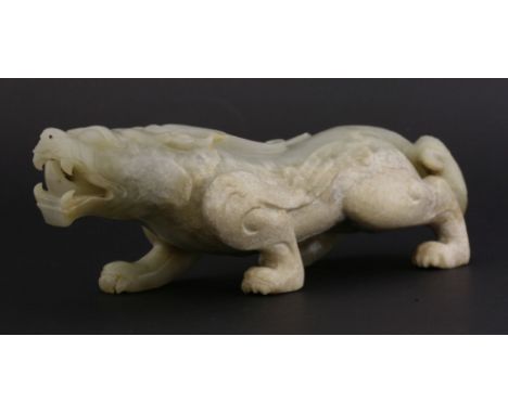 A jade Mythical Beast,first half of the 20th century, the powerful beast crouching forward, flames springing from his shoulde