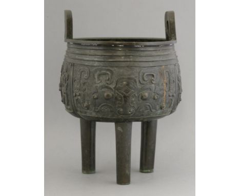 A bronze tripod Censer,probably 18th century, the body cast in relief with taotie motifs below double string lines, the rim w