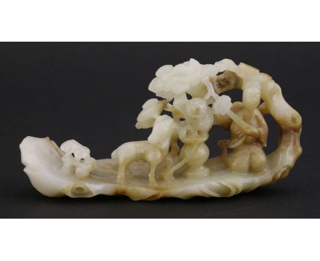 A jade Group,20th century, of a kneeling woman holding a ruyi sceptre, and with a goat flanking a vase of flowers beneath a c
