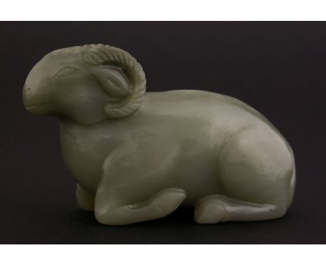 A jade Ram,18th/19th century, the grey-green recumbent beast with cream and black suffusions,10cm清十八/十九世纪 青灰玉卧羊把件