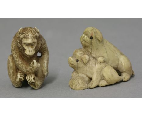 An ivory Okimono, c.1900, of a seated ape looking at his right hand, its fur detailedly carved, 4cm; and another, of two pupp