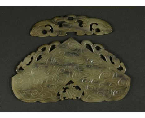 A jade Musical Stone,19th century, of typical form, carved and pierced with a fish, bat, dragons and scrolls and with matchin