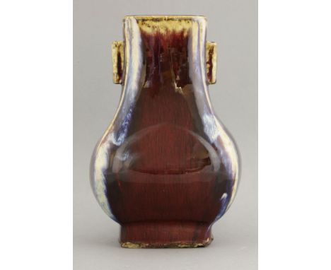 A flambé Hu,early 20th century, the rectangular pear body with 'arrow handles' and under a streaked oxblood glaze, the corner