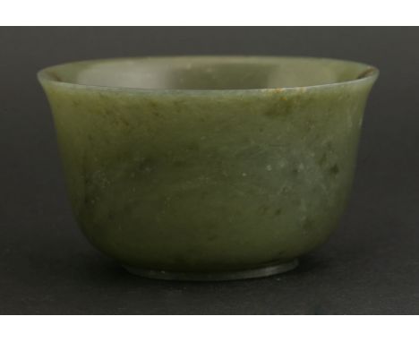 A spinach-green jade Bowl,mark and period of Qianlong (1736-1795), of deep form, the grey-green body with a mottled brown hoo
