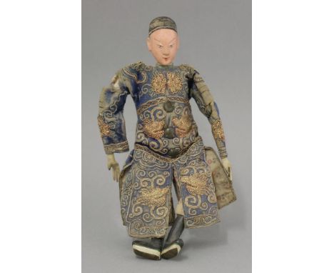 A papier mâché puppet, c.1870, wearing gilt-thread-embroidered blue dress, his face pink, 26.5cm