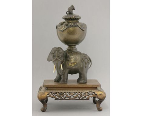 An attractive bronzed copper Koro and Cover,late 19th century, in the form of a bejewelled elephant standing four-square with