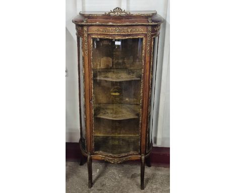 A 19th Century French Louis XV style walnut and gilt metal mounted serpentine vitrine 