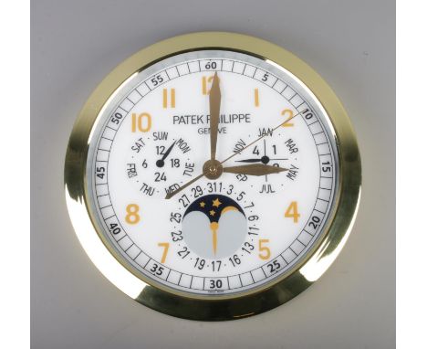 A Patek Philippe watch style wall clock, featuring a gold bezel and white dial, quartz movement, diameter 40cm.  slight warp 