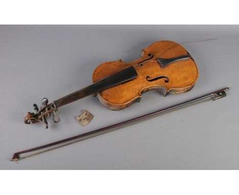 An antique violin and bow. Having 14inch two piece back. Bears spurious 'Antonio Stradivarius 1694' label.