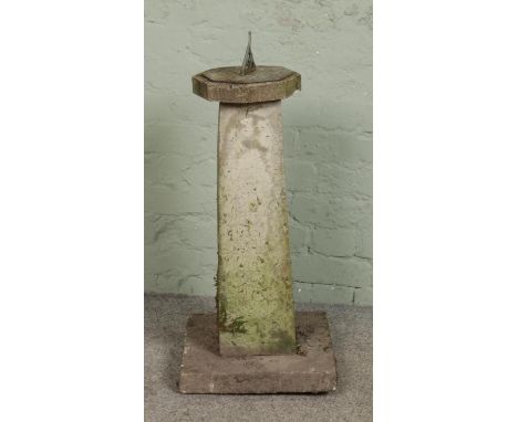 A composite stone pillar, topped with octagonal sundial. On square base. Height: 80cm.