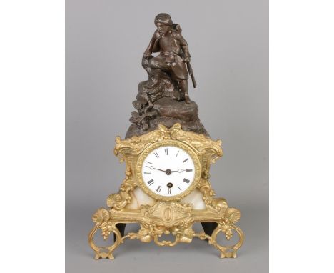 An antique bronze and marble French Empire mantel clock, depiction of a man with gun, with Roman numerals, no key and pendulu
