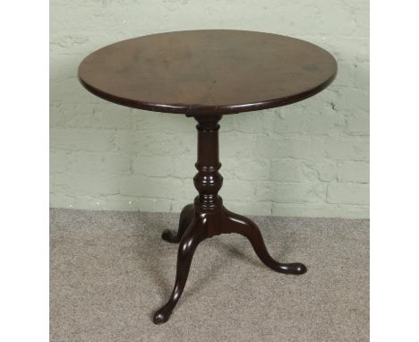 A Georgian mahogany tilt top bird cage table, raised on tripod base, diameter of top 71cm.