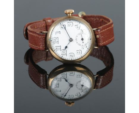 An early Twentieth Century 9ct Gold cased manual wind trench watch, on brown strap. Bearing Arabic Numeral markers and with s
