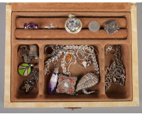 A jewellery box with contents of silver and white metal jewellery. Includes rings, thimble, pendants, brooches, coins etc.