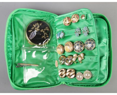 A green case of costume jewellery. Includes twenty five pairs of clip on earrings, Stratton compact, Dunhill tie slide etc.