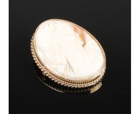 A vintage 9ct yellow gold mounted cameo brooch. Portrait of a maiden, with rope twist border. Maker's mark EJCY &amp; Co. 4cm