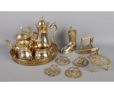 A collection of metalware, including a brass tea set with tray, horse brasses, brass irons and boot etc.