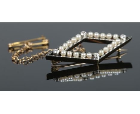 A Gold diamond shaped brooch, set with four diamonds to the corners, between a row of five seed pearls, mounted within a whit