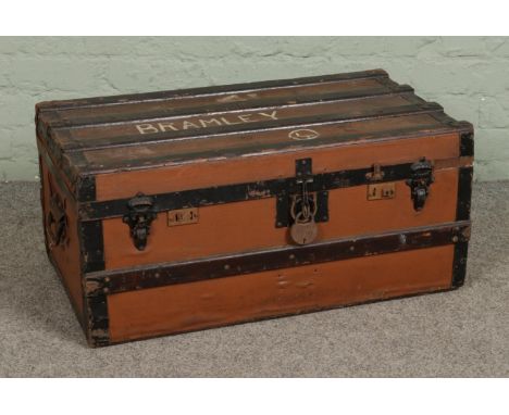 A wooden bound travel trunk, with hinged top. 'Bramley' stamped to the top. Height: 35cm, Width: 76cm, Depth: 42cm.