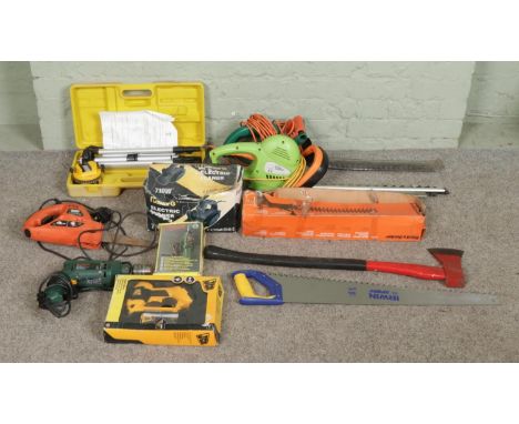 A collection of power tools and hand tools, including axe, saw, electrical trimmers and Bosch tools etc.