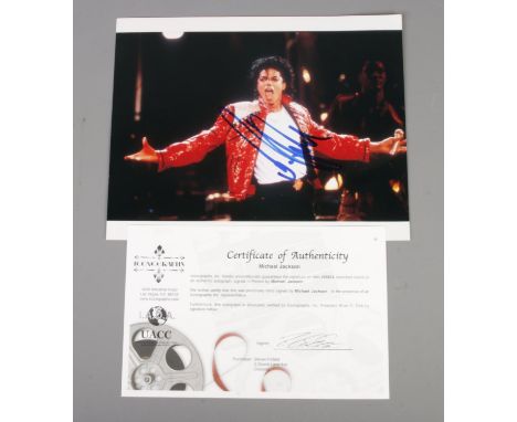 A signed Michael Jackson colour photograph with Certificate of Authenticity to the reverse. Purportedly signed in 2004 at Fir
