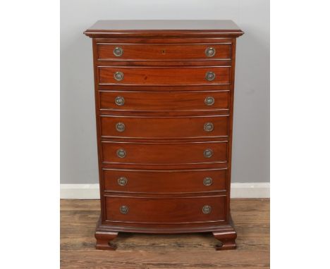 A Regency style mahogany bow front chest of drawers from "The Kingswood Collection", seven drawers with brass ring handles, r